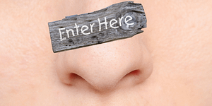Human nose with rustic Enter Here sign above it